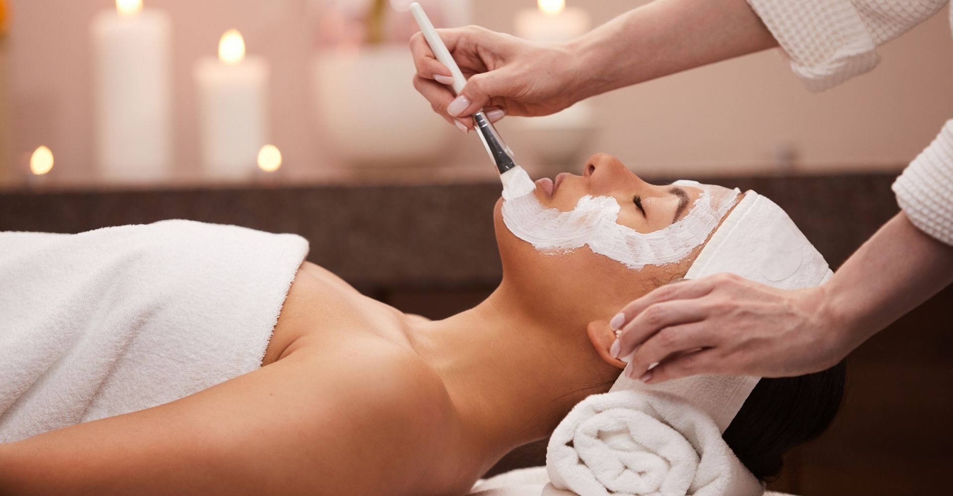 woman having facial cream applied