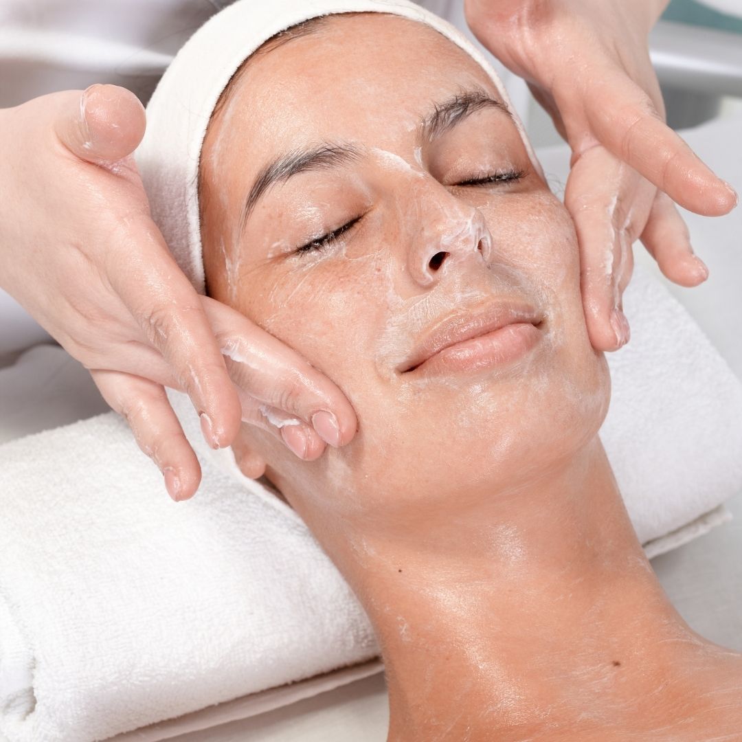 woman having a cream rubbed into her skin