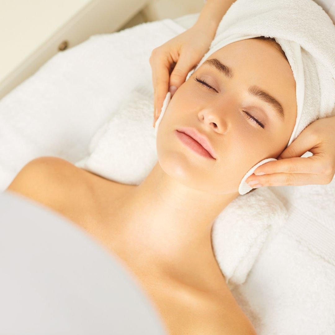 woman having pads rubbed against her cheeks