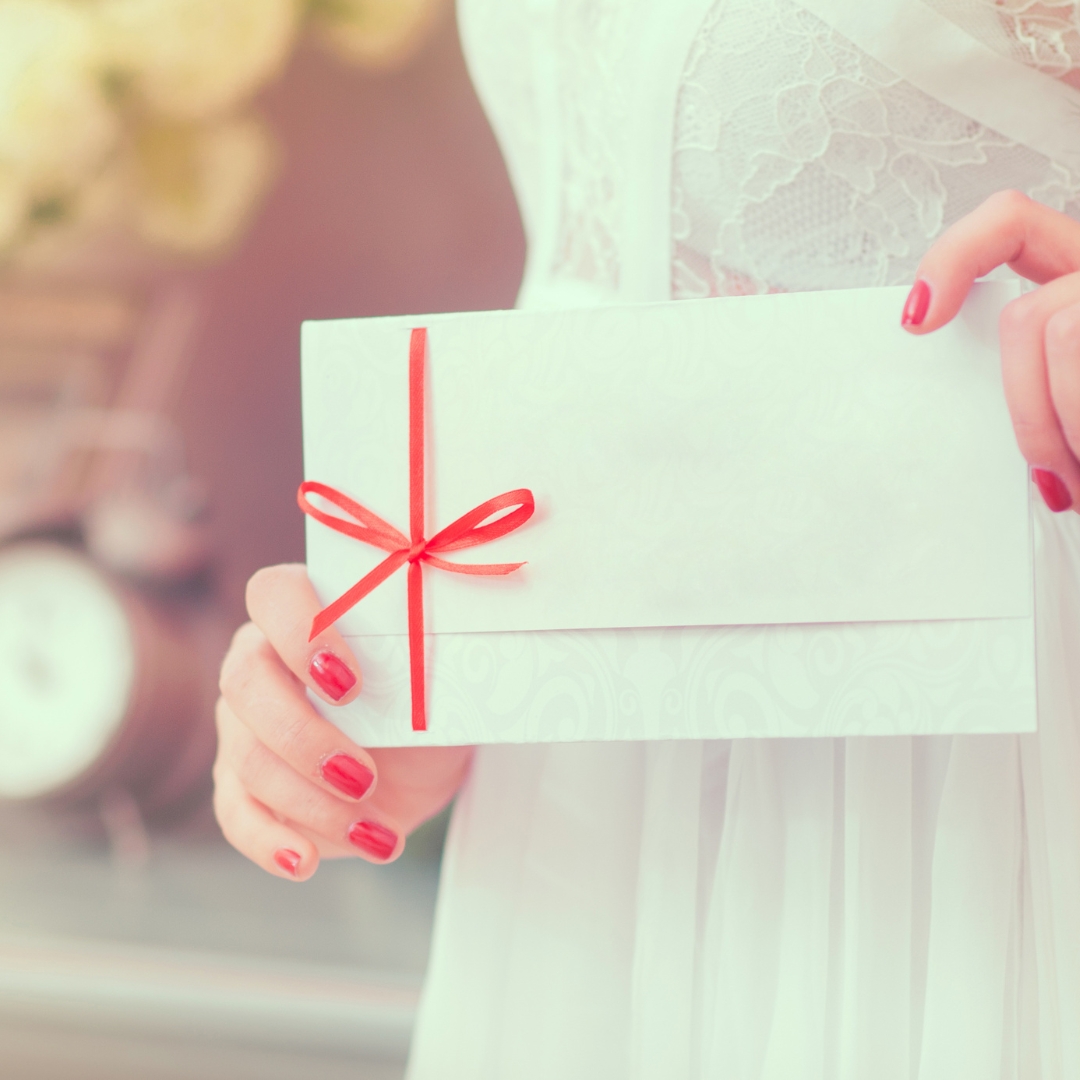 woman giving gift in envelope