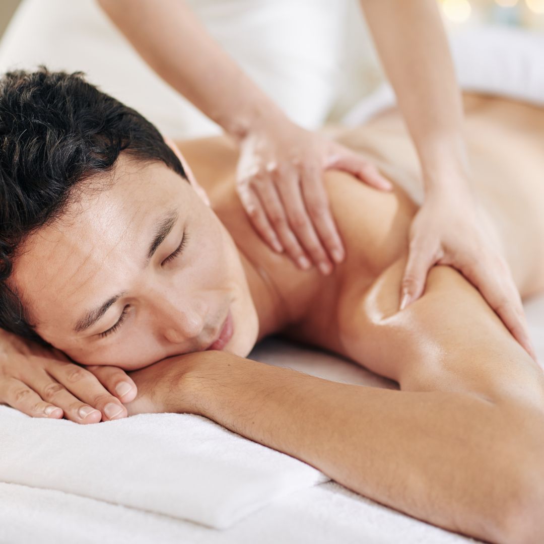 man getting shoulder massaged