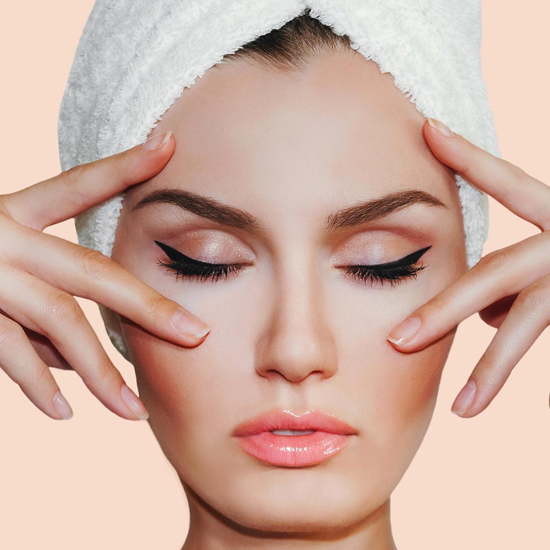 woman with her hands next to her face