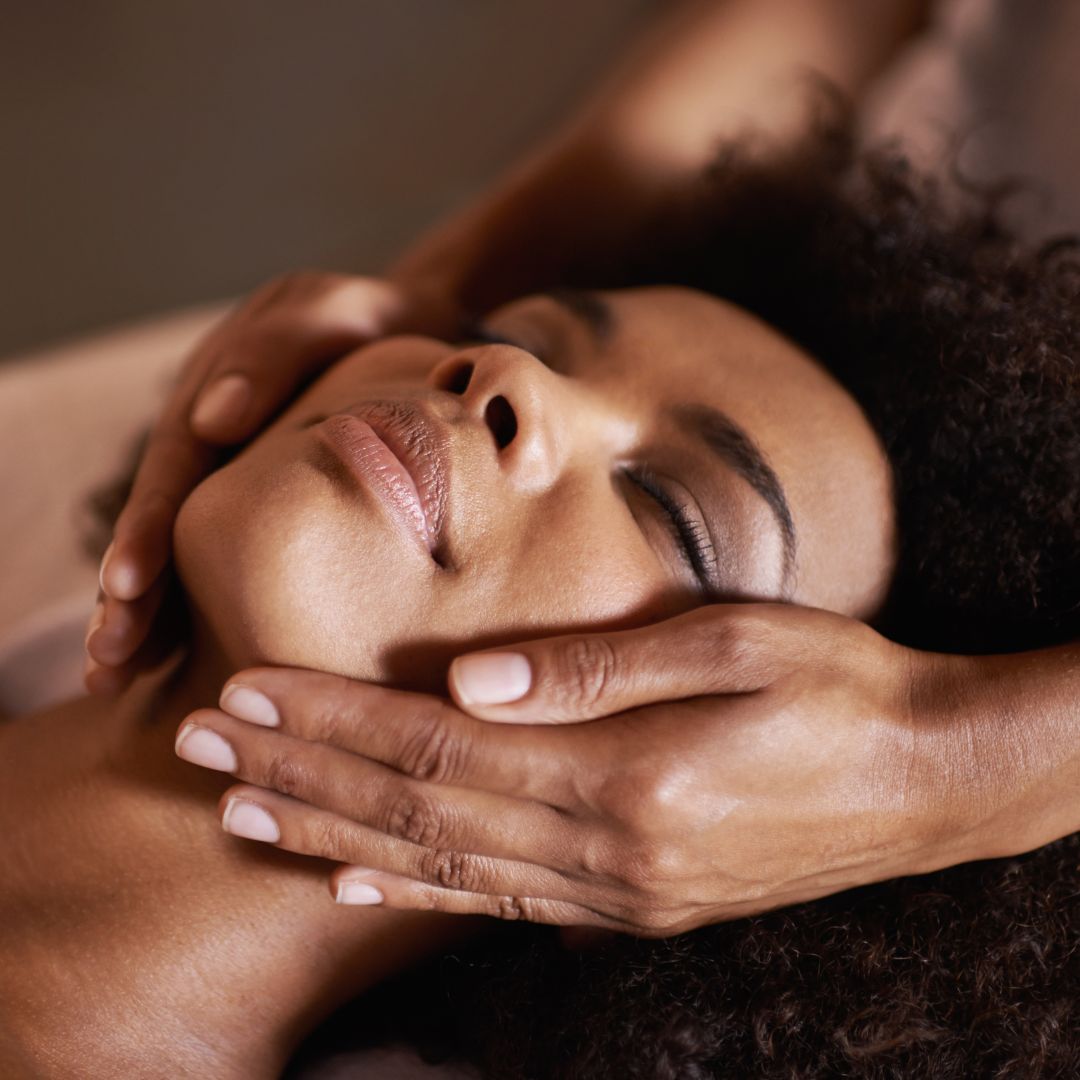 a woman receiving a facial massage