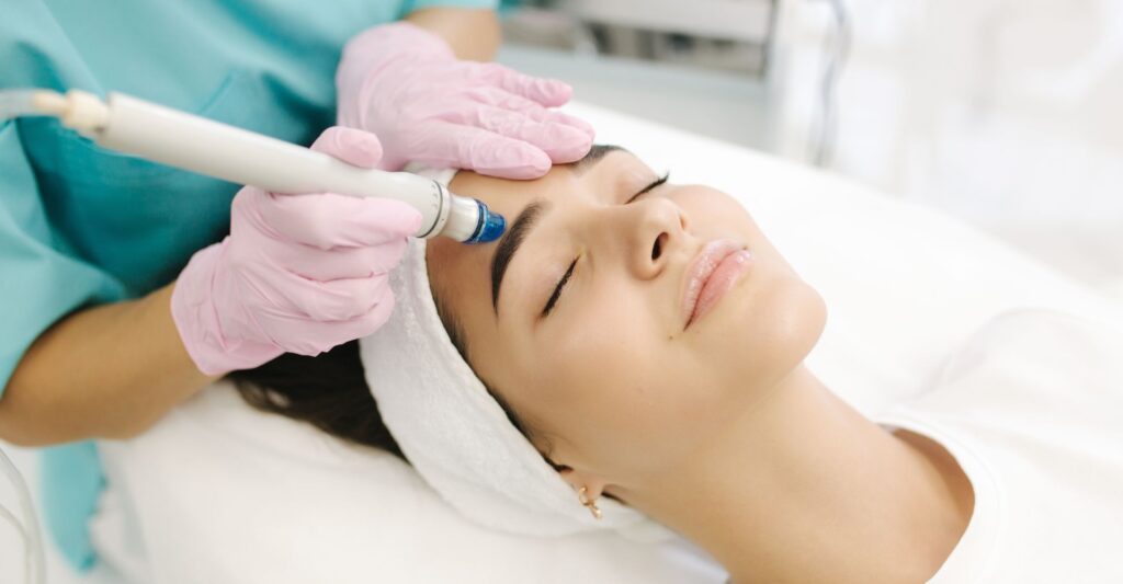 a woman receiving a hydrafacial treatment
